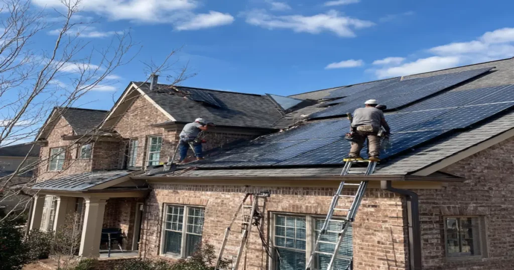 Electricians installing solar panels on Alpharetta home rooftop