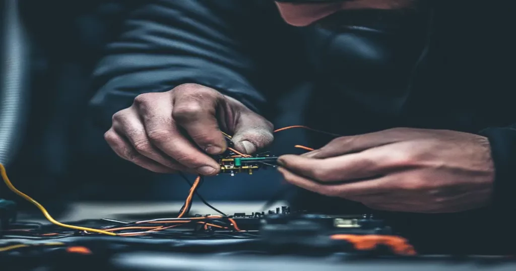 Electrician connecting advanced energy-efficient wiring components in Columbus, GA.
